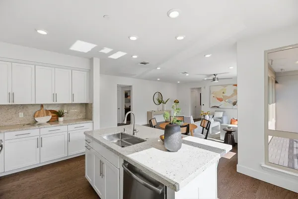 a kitchen with a sink a stove and cabinets