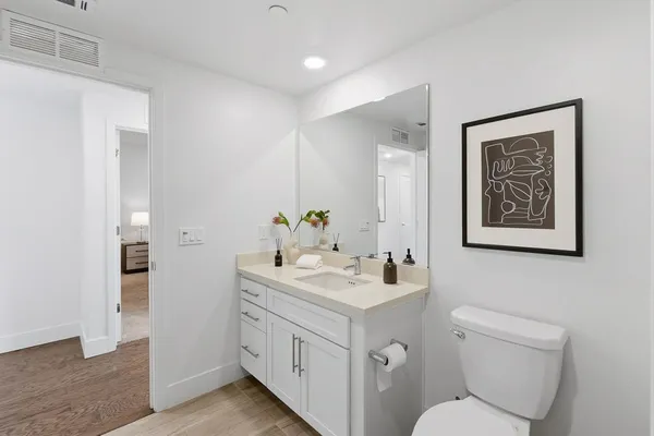 a bedroom with bed and a night stand