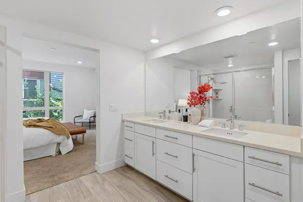 a front view of a building with lot of trees and plants