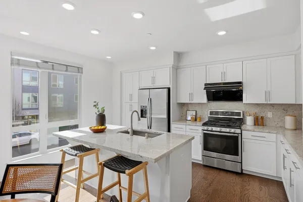 a kitchen with a stove a microwave and a refrigerator