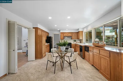 a kitchen with a table and chairs
