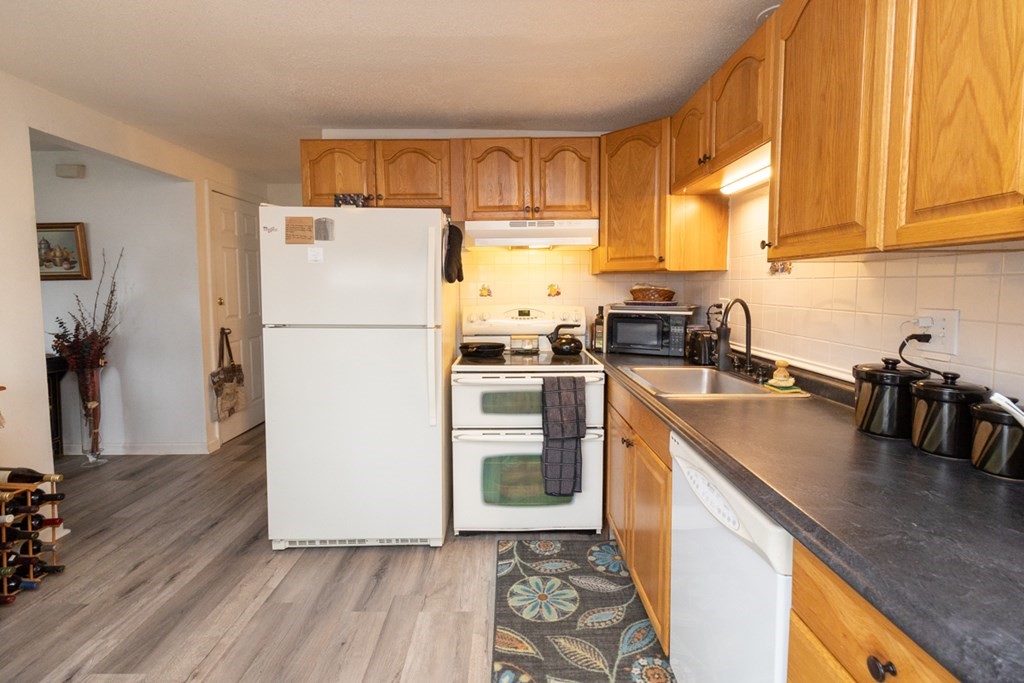269 Chicopee Street, Unit 16 Chicopee, MA 01013 - Photo 11 of 26 a kitchen with granite countertop a refrigerator stove top oven and sink