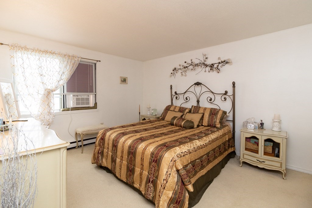 269 Chicopee Street, Unit 16 Chicopee, MA 01013 - Photo 14 of 26 a bedroom with a bed and a window
