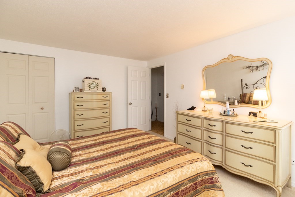 269 Chicopee Street, Unit 16 Chicopee, MA 01013 - Photo 15 of 26 a bedroom with a bed and a dresser