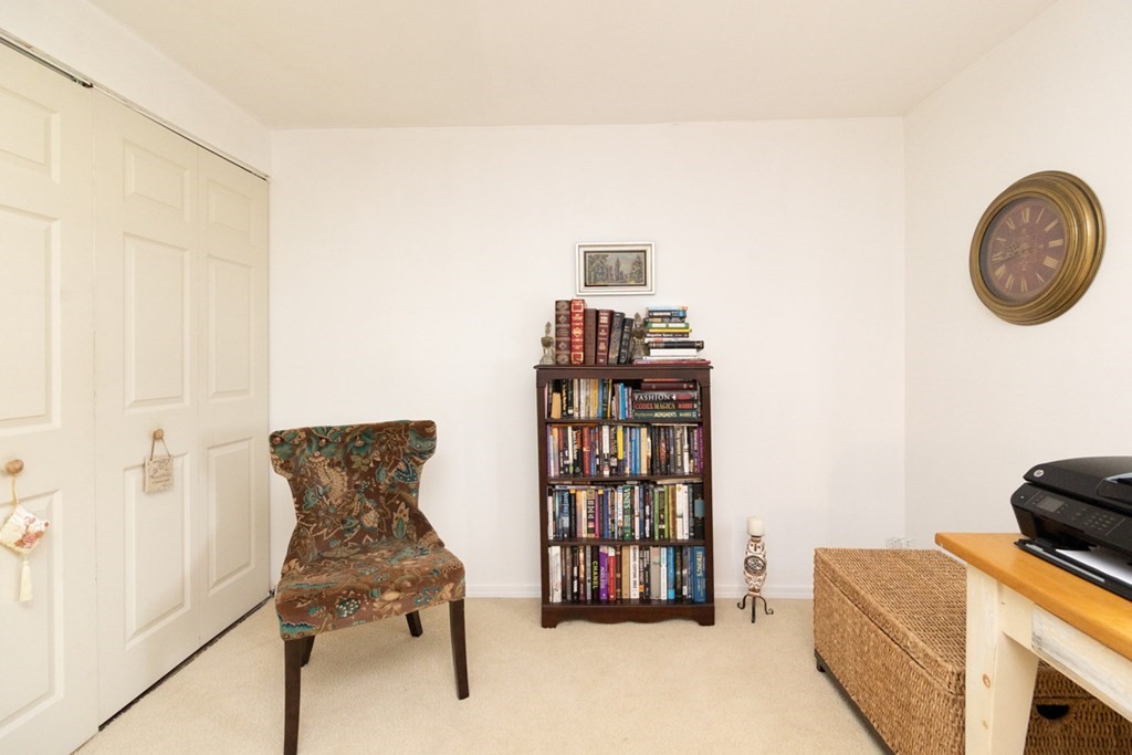 269 Chicopee Street, Unit 16 Chicopee, MA 01013 - Photo 19 of 26 a bedroom with furniture and a book shelf