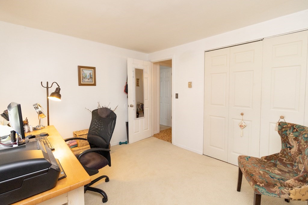 269 Chicopee Street, Unit 16 Chicopee, MA 01013 - Photo 20 of 26 a view of a workspace with furniture and a bedroom