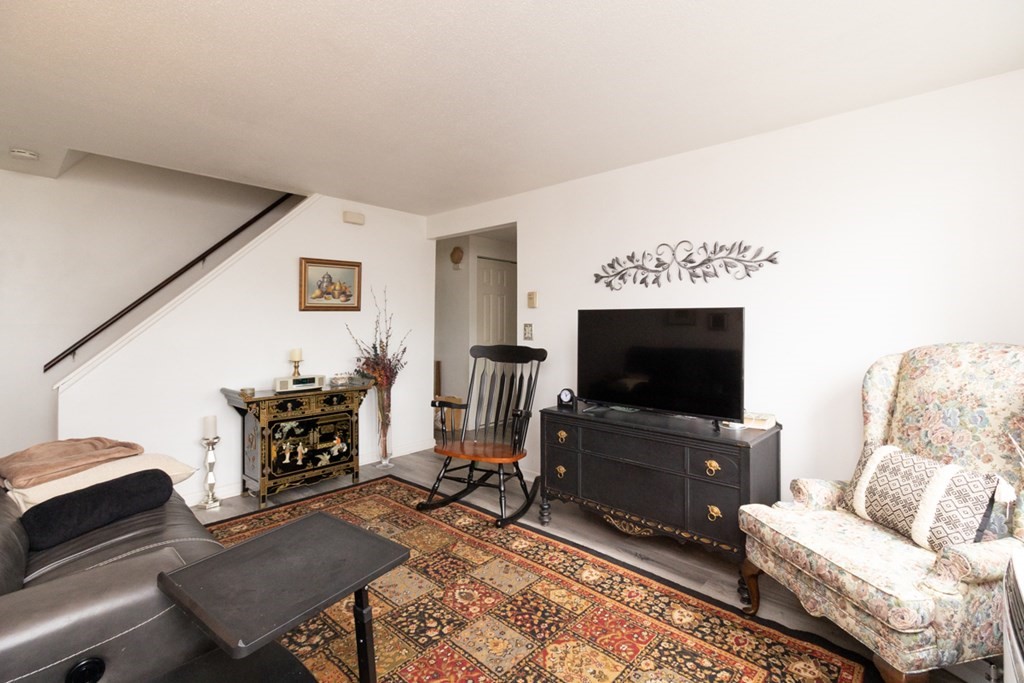 269 Chicopee Street, Unit 16 Chicopee, MA 01013 - Photo 2 of 26 a living room with furniture and a flat screen tv