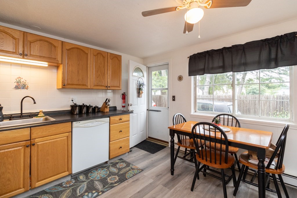 269 Chicopee Street, Unit 16 Chicopee, MA 01013 - Photo 8 of 26 a kitchen with stainless steel appliances granite countertop a table chairs sink and cabinets