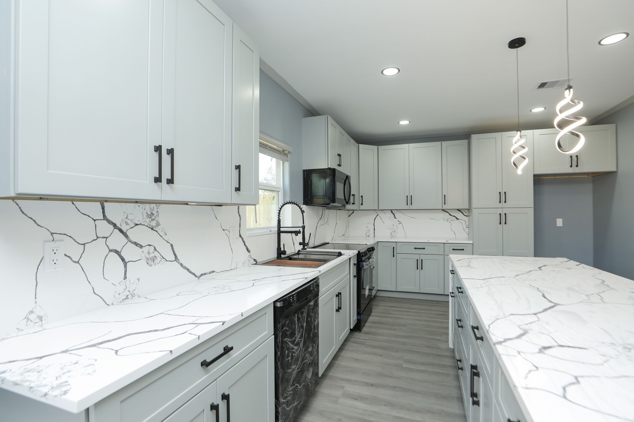 4047 Juliet Street Houston, TX 77087 - Photo 13 of 38 a kitchen with a sink stove and cabinets