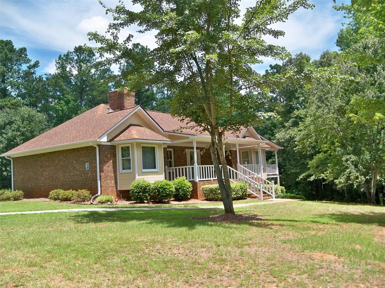 402 Weldon Lake Road Milner, GA 30257 - Photo 1 of 1 a front view of a house with a garden