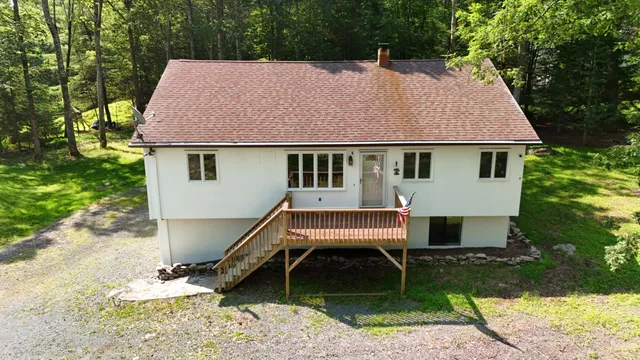 a aerial view of a house with a yard and sitting area