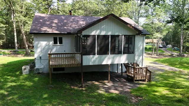 a view of a chair and table in backyard of the house