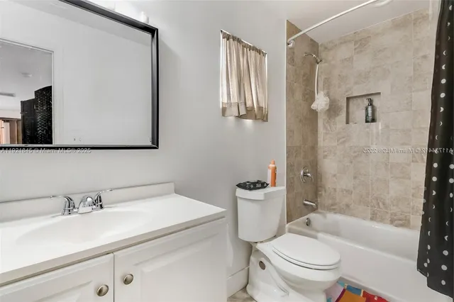 a bathroom with a sink toilet a mirror and shower