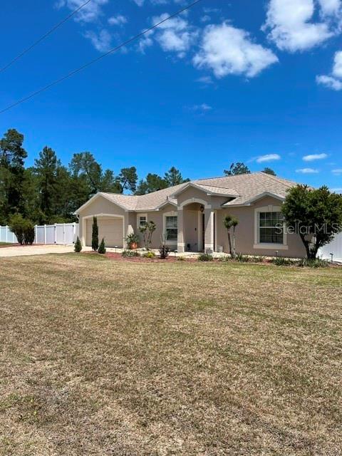 10985 Southwest 48th Terrace Ocala, FL 34476 - Photo 2 of 73 a front view of a house with a yard