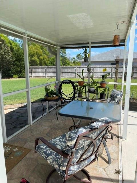 10985 Southwest 48th Terrace Ocala, FL 34476 - Photo 60 of 73 a dining room with furniture and floor to ceiling window