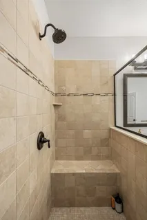 a bedroom with a bed mirror and a window