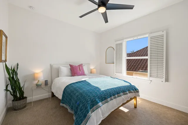 a bedroom with bed and window