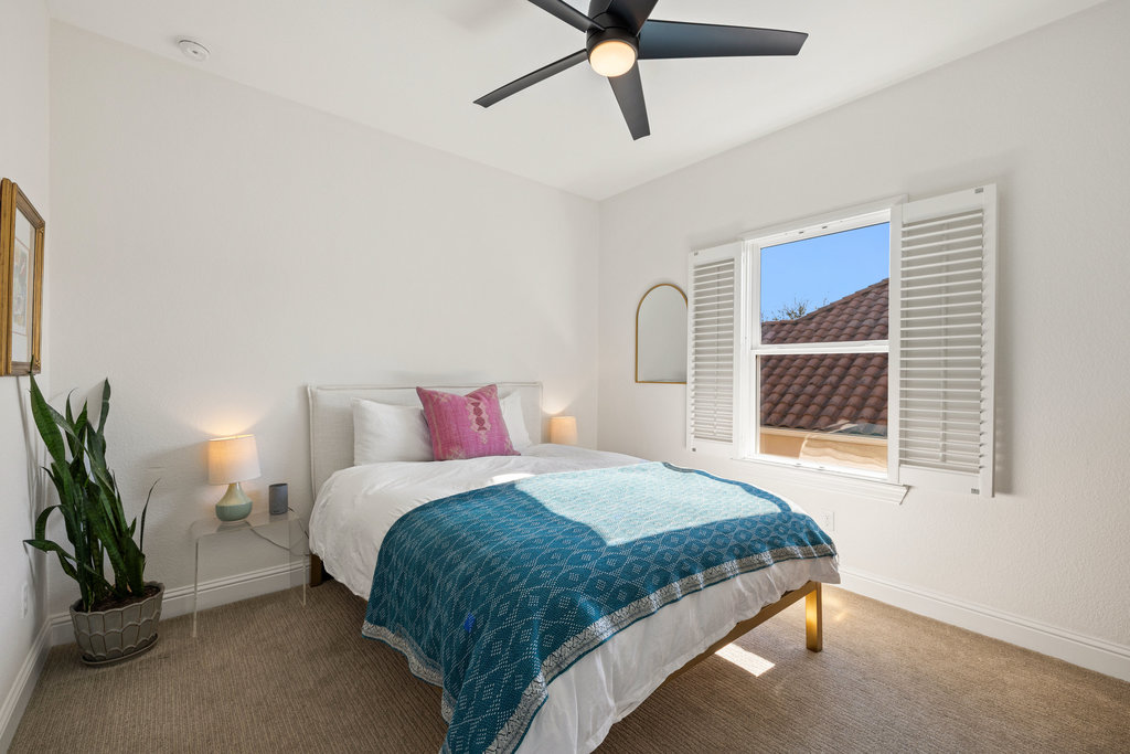 9116 Villa Norte Drive Austin, TX 78726 - Photo 16 of 40 a bedroom with a bed mirror and a window