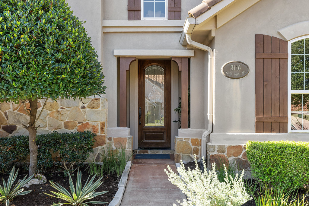 9116 Villa Norte Drive Austin, TX 78726 - Photo 2 of 40 a front view of a house with garden
