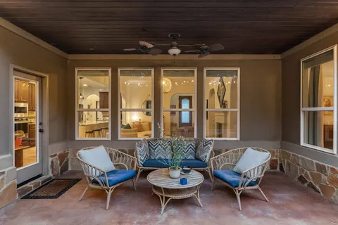 a view of a chair and tables in the patio