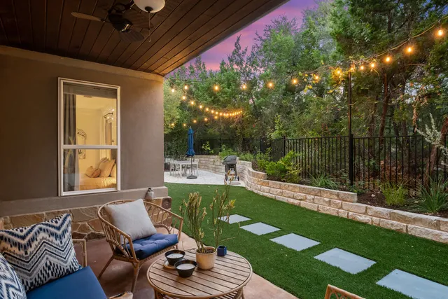 a aerial view of a house with swimming pool and large trees