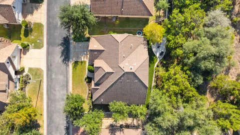 an aerial view of residential houses with outdoor space and street view