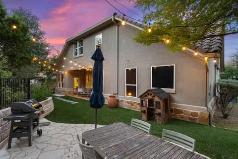 a view of a patio with a table chairs and a fire pit