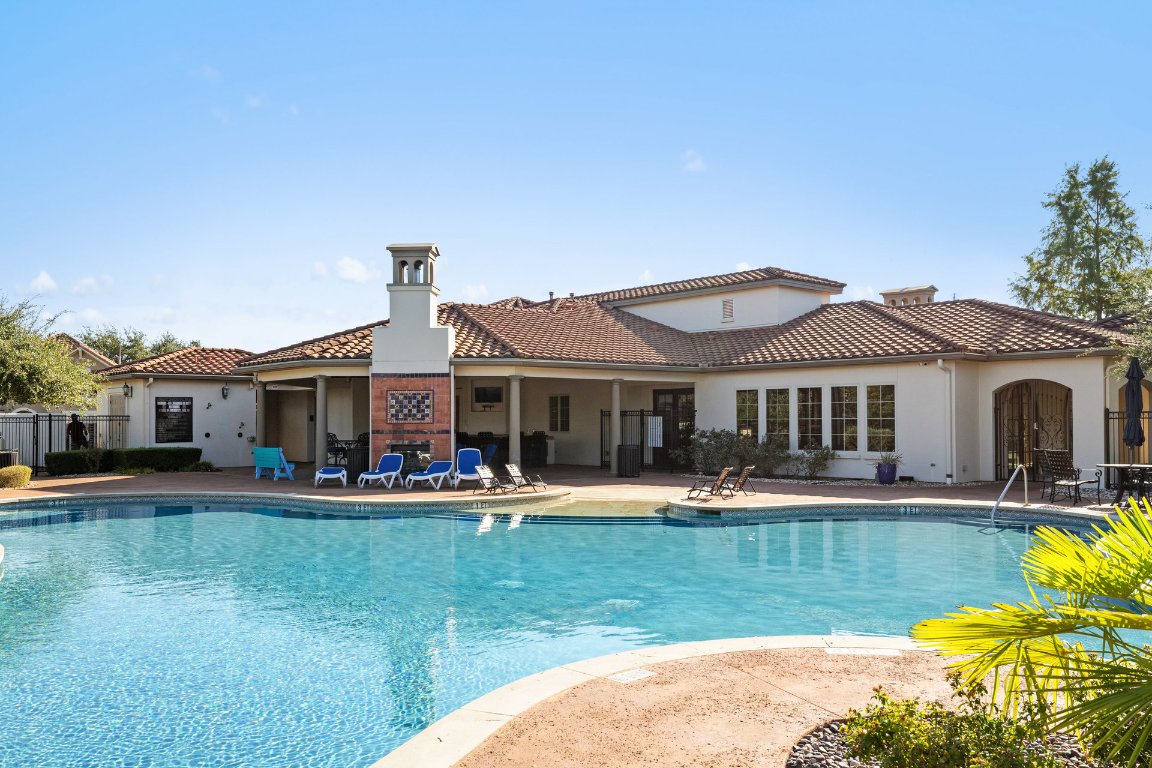 9116 Villa Norte Drive Austin, TX 78726 - Photo 34 of 40 a front view of a house with swimming pool and chairs