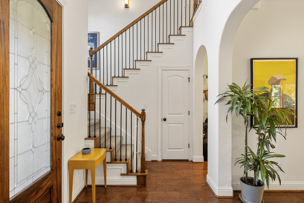 9116 Villa Norte Drive Austin, TX 78726 - Photo 4 of 40 a view of staircase with wooden floor and a potted plant
