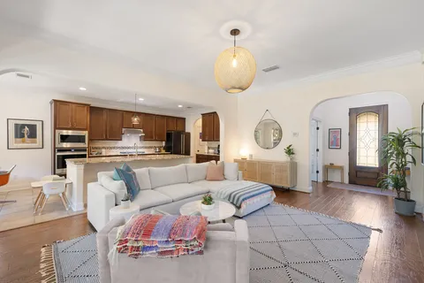 a living room with furniture and kitchen view