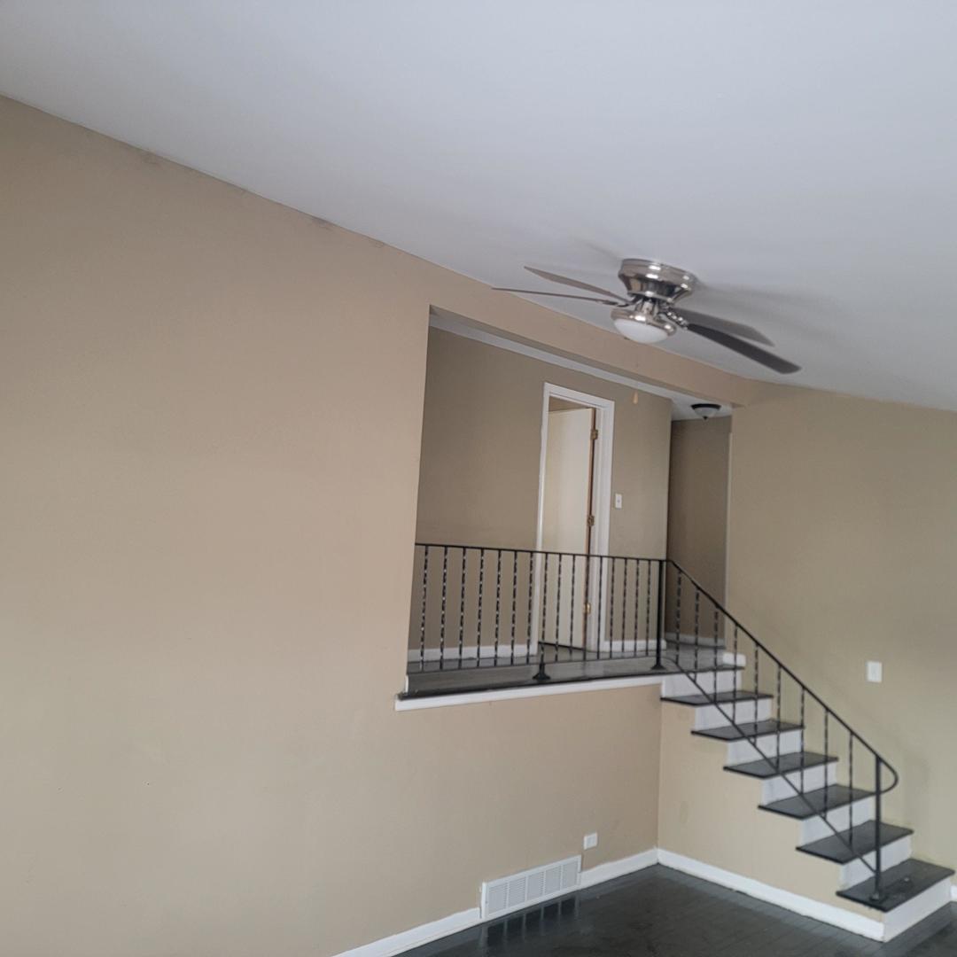 16444 Wolcott Avenue Markham, IL 60428 - Photo 7 of 18 a view of staircase with railing and white walls