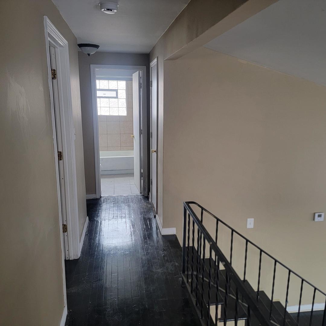16444 Wolcott Avenue Markham, IL 60428 - Photo 9 of 18 a view of a hallway with wooden floor