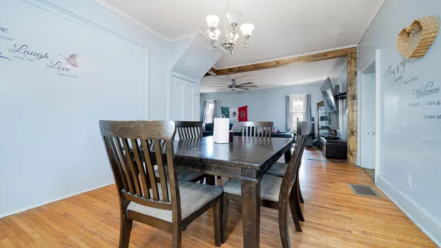 a view of a dining room with furniture and wooden floor