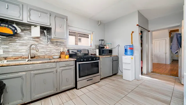 a kitchen with stainless steel appliances granite countertop a stove a sink and a refrigerator