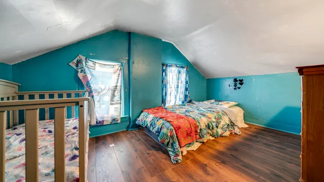 a bedroom with a bed and a bookshelf