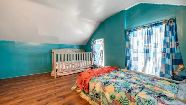 a bedroom with a bed and a window