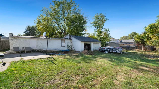 a backyard of a house with table and chairs