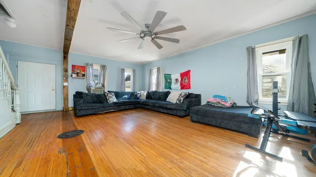a living room with furniture and a wooden floor