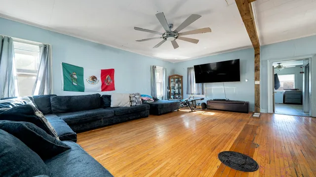 a living room with furniture and a flat screen tv