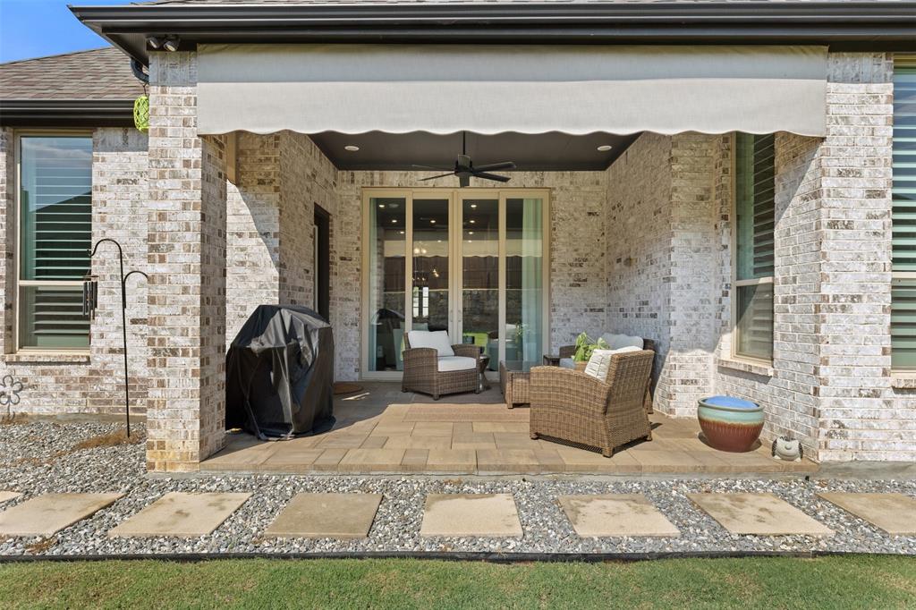 9716 Wilderness Road Little Elm, TX 75068 - Photo 33 of 39 Covered patio featuring a ceiling fan and a retractable awning