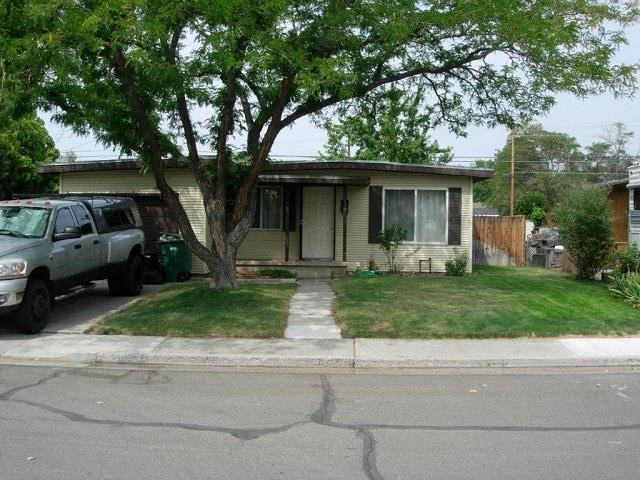 1695 Auburn Way Reno, NV 89502 - Photo 1 of 1 a front view of a house with a garden and trees