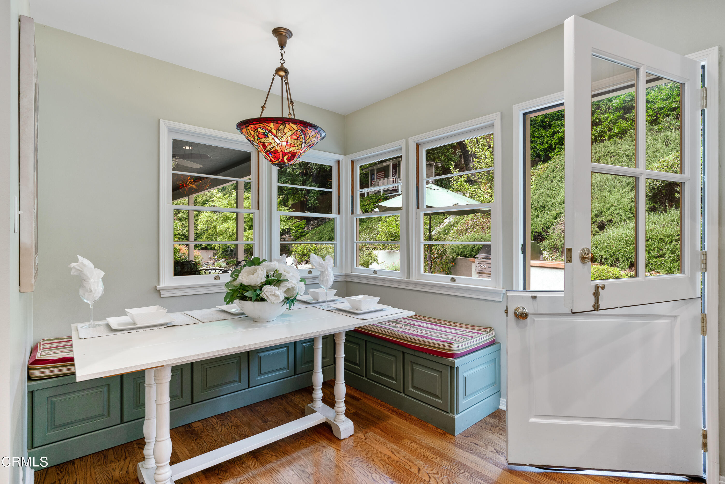 1265 Inverness Drive Pasadena, CA 91103 - Photo 15 of 44 a dining room with wooden floor and a chandelier