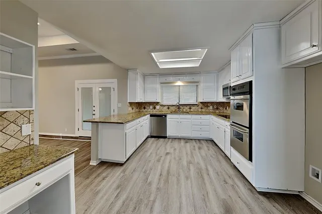 a large kitchen with a white stove top oven and refrigerator
