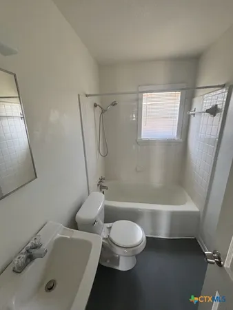 a bathroom with a sink a toilet and a bathtub
