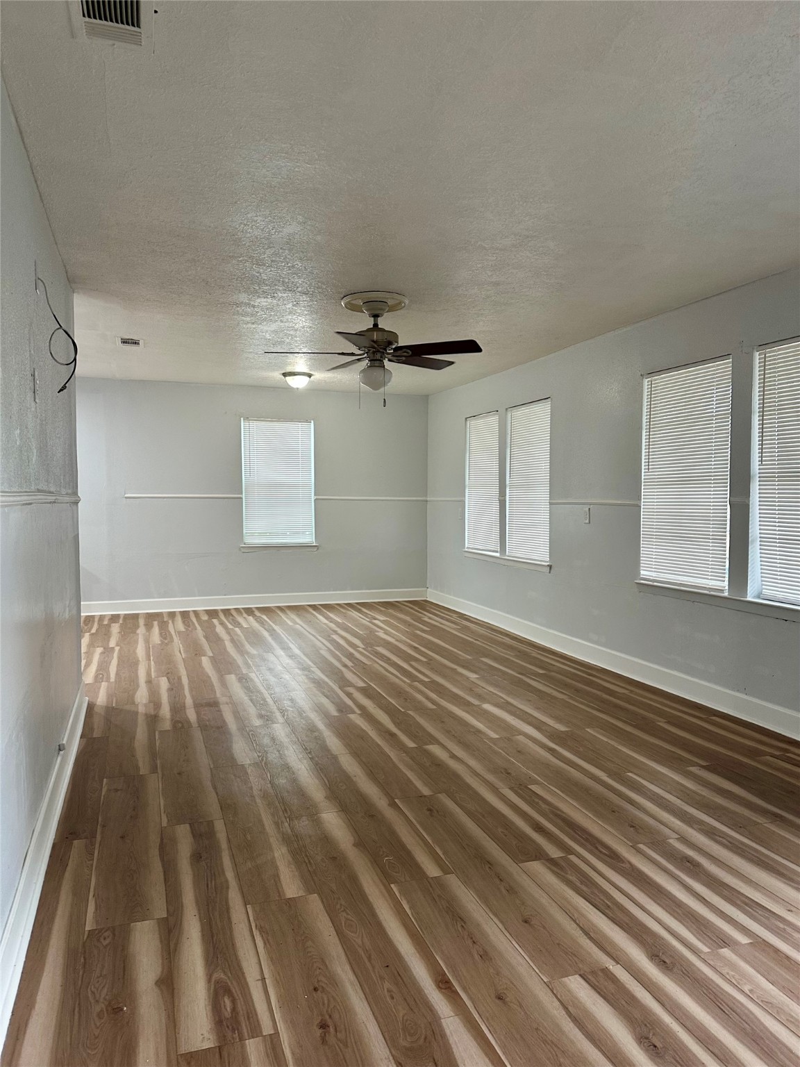 4123 Littlecrest Road Houston, TX 77093 - Photo 3 of 16 wooden floor in an empty room with a window