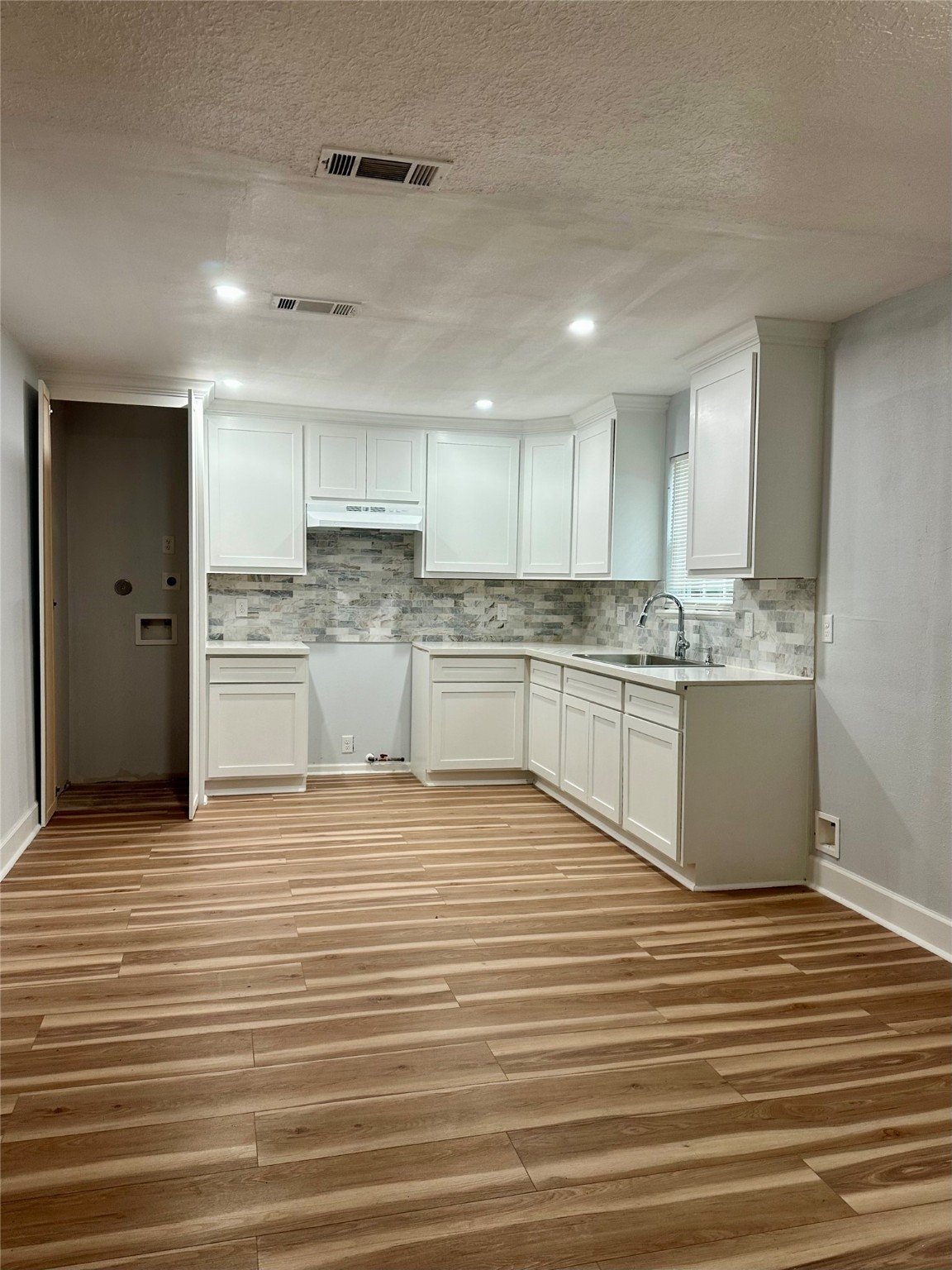 4123 Littlecrest Road Houston, TX 77093 - Photo 4 of 16 a large kitchen with stainless steel appliances granite countertop a sink and cabinets