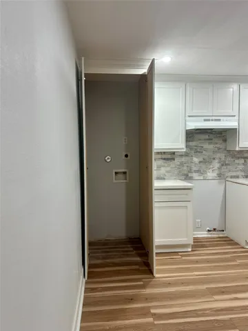 a view of a kitchen from the hallway