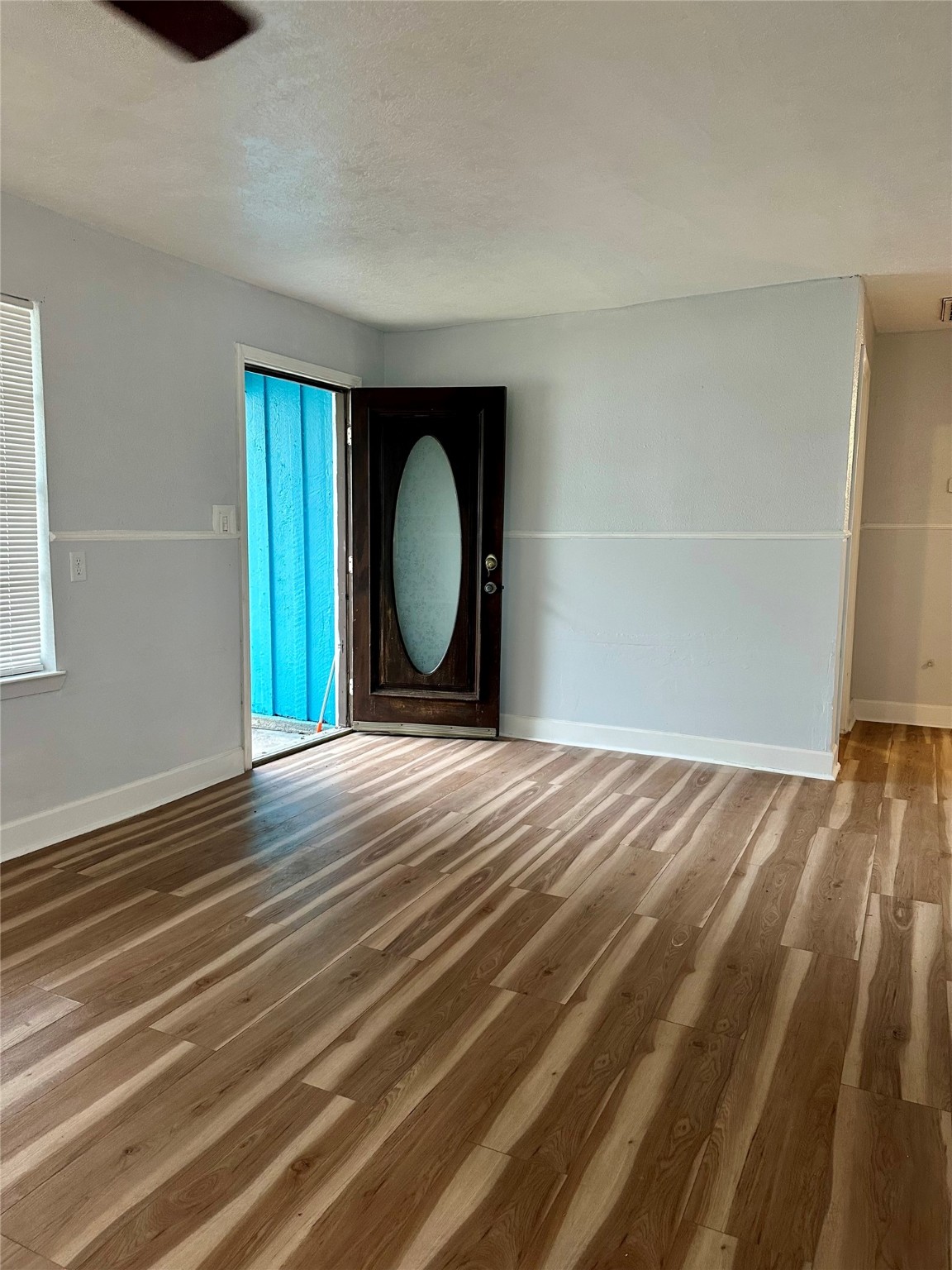 4123 Littlecrest Road Houston, TX 77093 - Photo 7 of 16 a view of empty room with wooden floor and fan