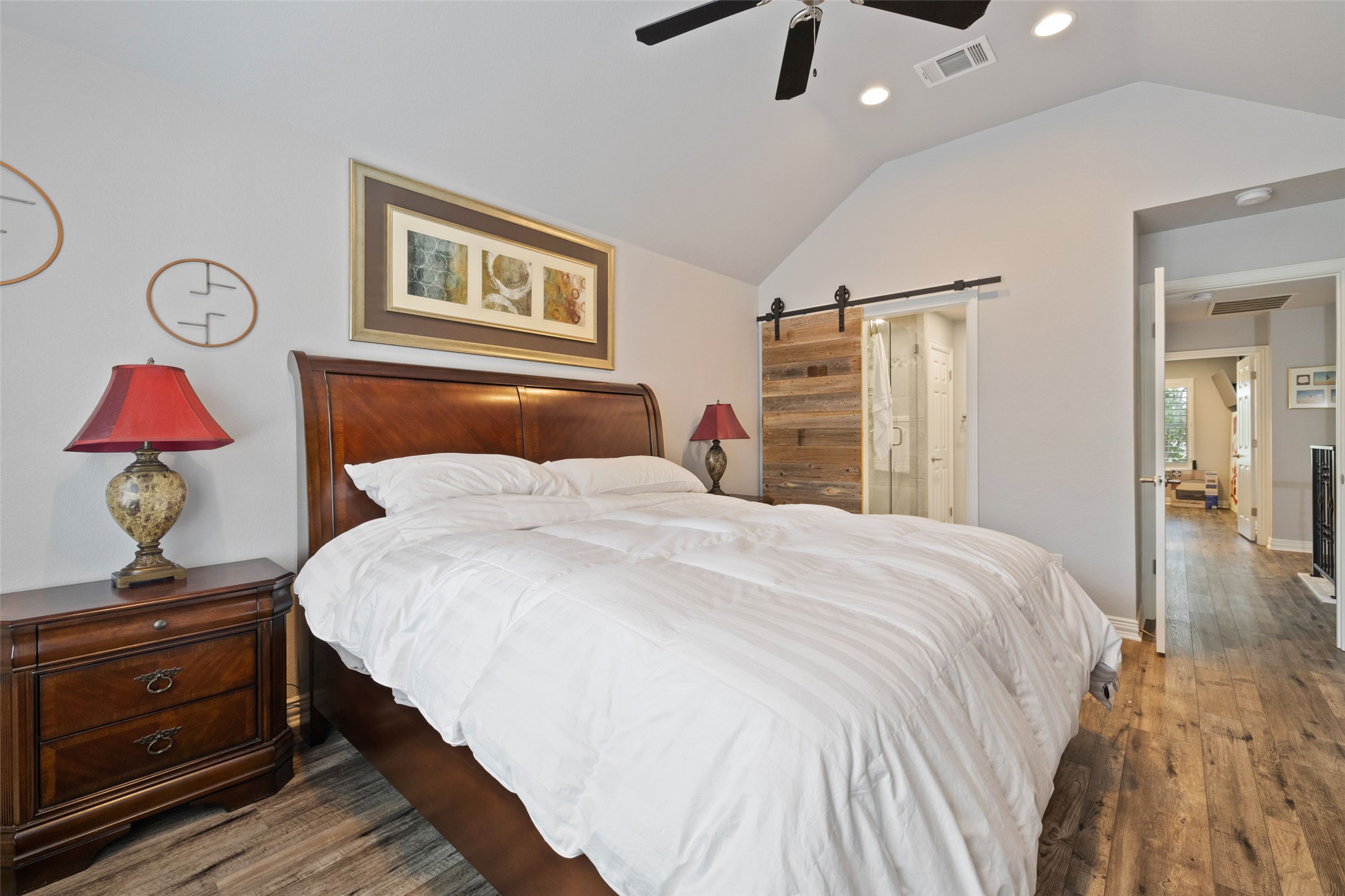 134 Prairie Springs Cove Georgetown, TX 78626 - Photo 17 of 34 a bedroom with a bed and a chandelier