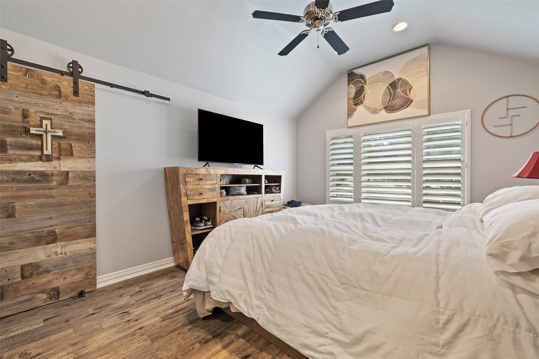 134 Prairie Springs Cove Georgetown, TX 78626 - Photo 19 of 34 a bedroom with a bed and a flat screen tv